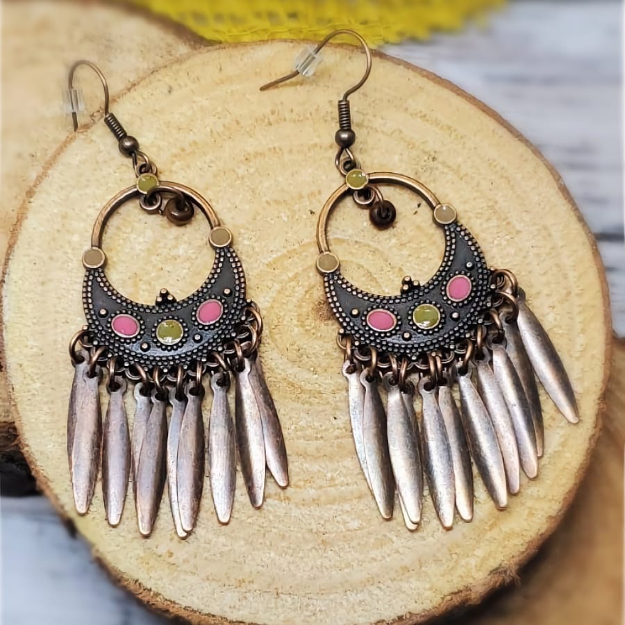 Close-up of a single oxidised earring showing crescent design, colorful stones, and detailed metallic dangles - detail | Zuzu