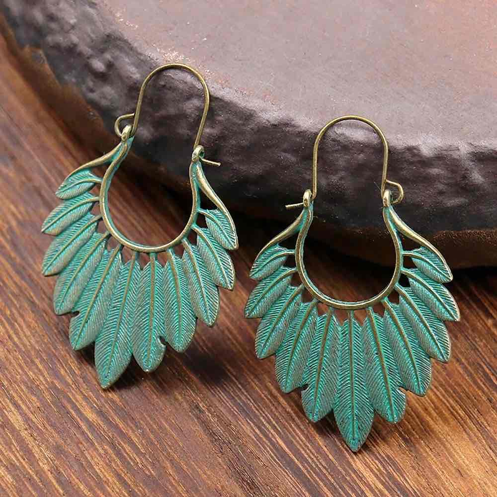 Boho blue oxidised earrings with antique finish hanging on bamboo - side view | Zuzu's Trove