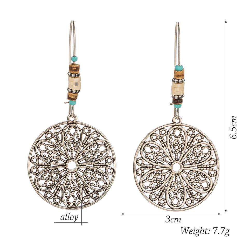 Pair of Oxidised Silver Dangle Earrings with elegant filigree design and wood-tone beads - Angled view | Zuzu's Trove