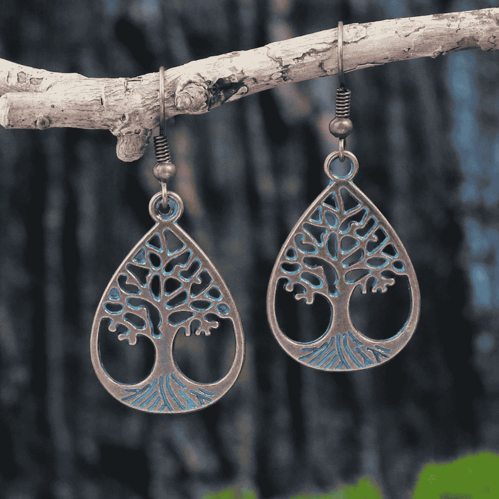 Blue oxidised earrings with Tree of Life design hanging on a branch - front view | Zuzu's Trove