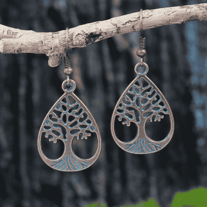 Blue oxidised earrings with Tree of Life design hanging on a branch - front view | Zuzu's Trove