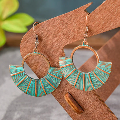 Close-up of a single blue oxidised fan earring featuring antique patina and radial lines - detail view | Zuzu's Trove