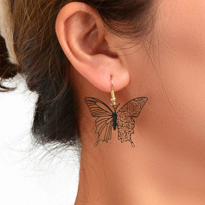 Butterfly Earring on a person's neck with a blurred background