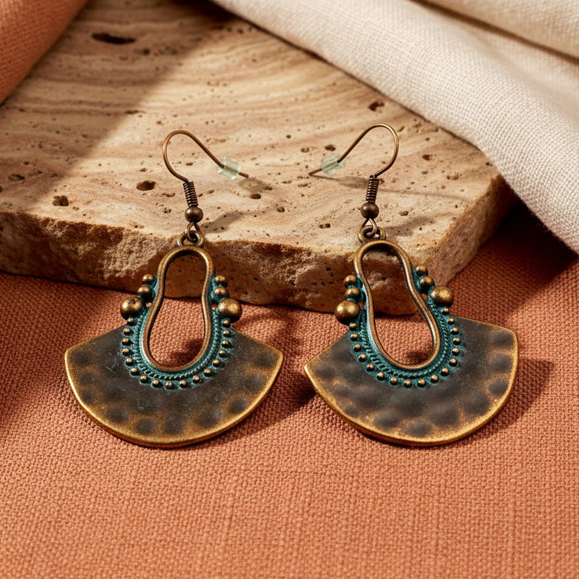 Oxidised Tribal Fan Dangle Earrings with Teal Patina - Pair, front view on textured background | Zuzu's Trove