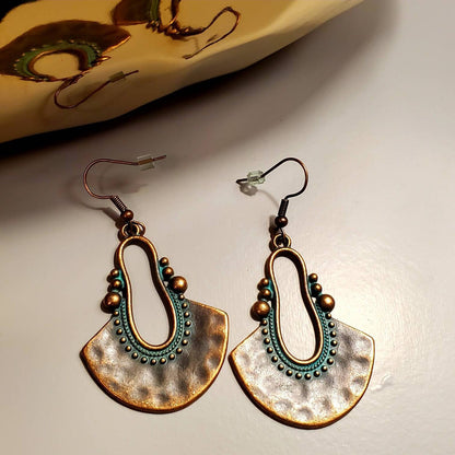 Oxidised Tribal Fan Dangle Earrings with Teal Patina - Right earring top detail on stone and fabric | Zuzu's Trove
